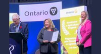 Minister Thompson presents Kathryn Doan with award
